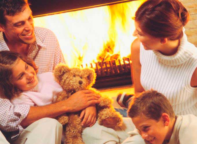 Family around the wood-burning fireplace 